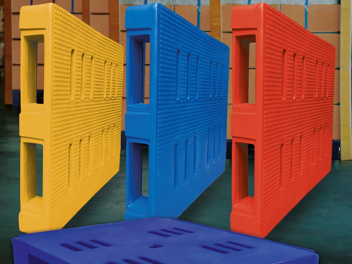 Yellow, blue and red plastic pallets in a warehouse